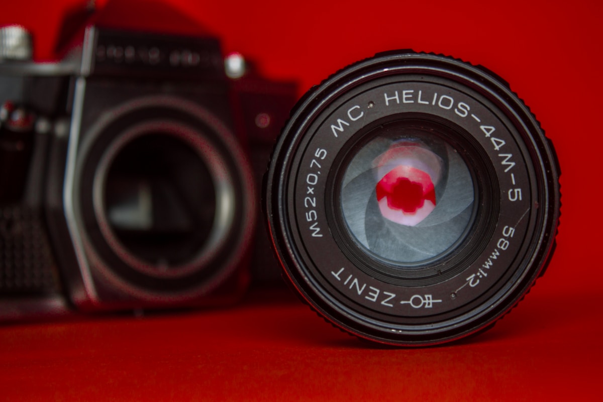 a close up of a camera with a red background