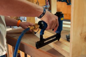 a person using a power drill on a piece of wood