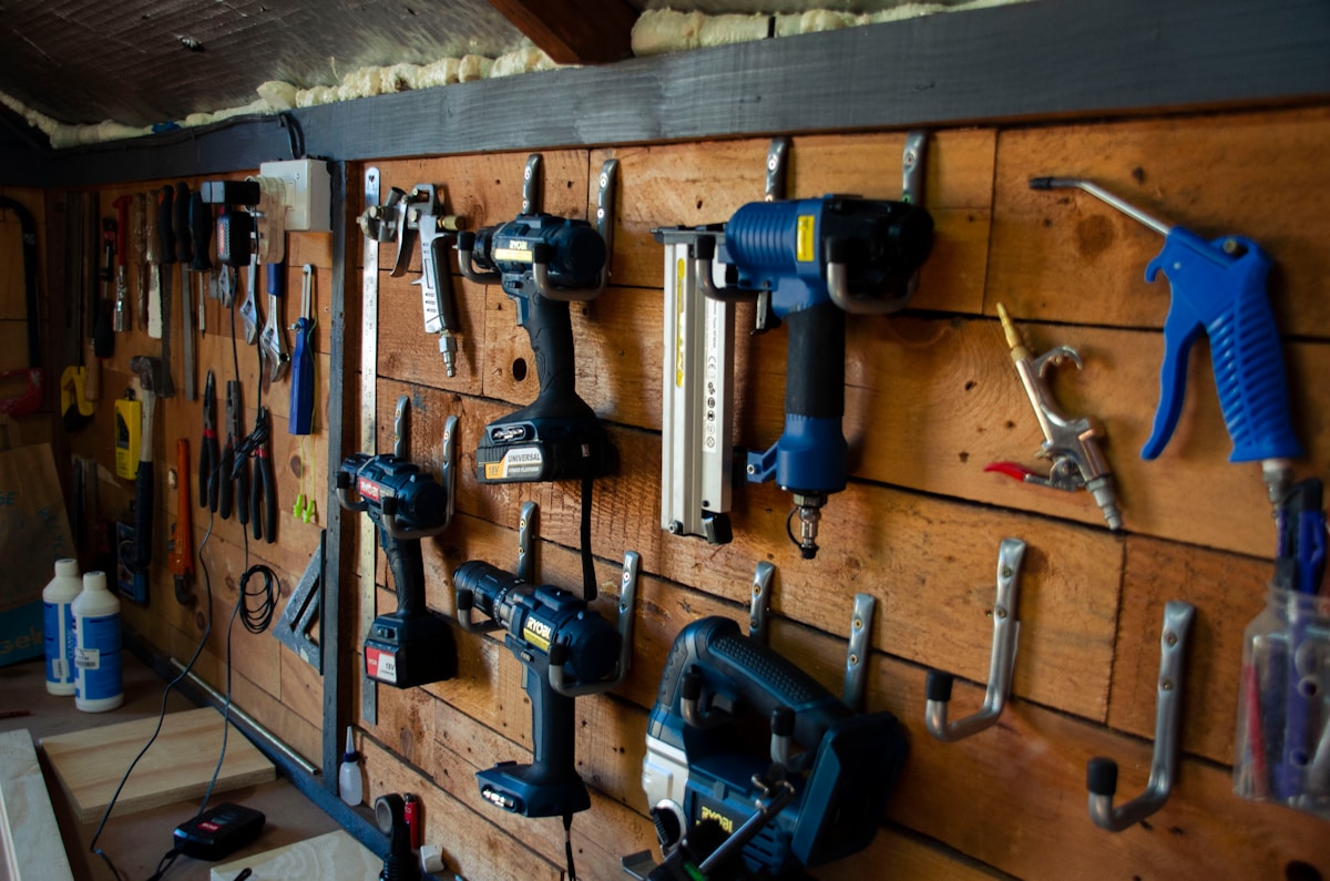 a bunch of tools are hanging on a wall